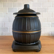 Load image into Gallery viewer, This vintage figural ceramic black pot belly stove cookie jar was crafted by McCoy Pottery in the 1960s. It's a must-have for any McCoy collector looking to add charm to their vintage cottage or farmhouse kitchen decor. This cookie jar is a perfect example of McCoy's expertise in creating high-quality and timeless pieces.
In excellent condition, no chip/cracks/repairs. There are a few tiny spots of glaze misses/loss.
Measures 6 3/4 x 7 x 10 3/8 inches