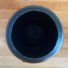 Load image into Gallery viewer, This vintage figural ceramic black pot belly stove cookie jar was crafted by McCoy Pottery in the 1960s. It's a must-have for any McCoy collector looking to add charm to their vintage cottage or farmhouse kitchen decor. This cookie jar is a perfect example of McCoy's expertise in creating high-quality and timeless pieces.
In excellent condition, no chip/cracks/repairs. There are a few tiny spots of glaze misses/loss.
Measures 6 3/4 x 7 x 10 3/8 inches