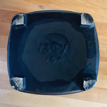 Load image into Gallery viewer, This vintage figural ceramic black pot belly stove cookie jar was crafted by McCoy Pottery in the 1960s. It's a must-have for any McCoy collector looking to add charm to their vintage cottage or farmhouse kitchen decor. This cookie jar is a perfect example of McCoy's expertise in creating high-quality and timeless pieces.
In excellent condition, no chip/cracks/repairs. There are a few tiny spots of glaze misses/loss.
Measures 6 3/4 x 7 x 10 3/8 inches