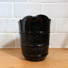 Load image into Gallery viewer, RARE! Gothic Victorian black pressed glass creamer jug. The lower 2/3 are stippled between smooth bands, while the top 1/3 is smooth. Produced by Davidson's, England, c1890 - 1910. A great piece to start a collection! In excellent vintage condition, free from chips/cracks/repairs. There is a manufacturer's defect on the underside of the foot near the mold line. Measures 2 3/4 x 3 1/2 inches (not including handle)