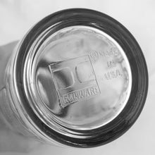 Load image into Gallery viewer, This iconic vintage mid-century glass cocktail shaker features 15 classic cocktail recipes in black, accented with fruits, cocktail graphics, a measuring scale in both ounces and litres, topped with a chrome lid. Crafted by Irvinware, USA 1970s. Reclaim the pleasure of being your home's star bartender...no Googling required!
In excellent condition, no chips or wear.
Measures 3 1/2 x 9 1/4 inches
Capacity 24 ounces or .710 litres