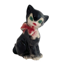 Load image into Gallery viewer, Adorable vintage mid-century black tuxedo cat sporting a pink bow ceramic planter. Crafted by Royal Copley, England, circa 1950. Use this sweet planter to enhance your home decor with your favourite plant. Easily repurpose to hold make-up brushes or office supplies. In great used vintage condition, free from chips/cracks/repairs. There is an occlusion in the ceramic and a bump in the glaze, see photos. The cat measures approximately 5 x 8 inches