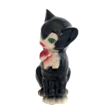 Load image into Gallery viewer, Adorable vintage mid-century black tuxedo cat sporting a pink bow ceramic planter. Crafted by Royal Copley, England, circa 1950. Use this sweet planter to enhance your home decor with your favourite plant. Easily repurpose to hold make-up brushes or office supplies. In great used vintage condition, free from chips/cracks/repairs. There is an occlusion in the ceramic and a bump in the glaze, see photos. The cat measures approximately 5 x 8 inches