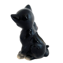 Load image into Gallery viewer, Adorable vintage mid-century black tuxedo cat sporting a pink bow ceramic planter. Crafted by Royal Copley, England, circa 1950. Use this sweet planter to enhance your home decor with your favourite plant. Easily repurpose to hold make-up brushes or office supplies. In great used vintage condition, free from chips/cracks/repairs. There is an occlusion in the ceramic and a bump in the glaze, see photos. The cat measures approximately 5 x 8 inches