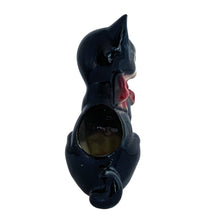 Load image into Gallery viewer, Adorable vintage mid-century black tuxedo cat sporting a pink bow ceramic planter. Crafted by Royal Copley, England, circa 1950. Use this sweet planter to enhance your home decor with your favourite plant. Easily repurpose to hold make-up brushes or office supplies. In great used vintage condition, free from chips/cracks/repairs. There is an occlusion in the ceramic and a bump in the glaze, see photos. The cat measures approximately 5 x 8 inches