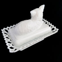 Load image into Gallery viewer, Gorgeous vintage white cat-on-nest milk glass dish featuring a lovely lace edge and blue glass eyes. Crafted by Westmoreland Glass, USA, circa 1950s/60s. A unique piece of pressed glass to use as a candy dish or catchall. A wonderful gift for the vintage glass enthusiast or cat lover!
In excellent condition, no chips, cracks or repairs. Lid and base have Westmoreland's maker's mark.
Measures 8 1/8 x 5 1/8 x 6 inches