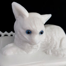 Load image into Gallery viewer, Gorgeous vintage white cat-on-nest milk glass dish featuring a lovely lace edge and blue glass eyes. Crafted by Westmoreland Glass, USA, circa 1950s/60s. A unique piece of pressed glass to use as a candy dish or catchall. A wonderful gift for the vintage glass enthusiast or cat lover!
In excellent condition, no chips, cracks or repairs. Lid and base have Westmoreland's maker's mark.
Measures 8 1/8 x 5 1/8 x 6 inches
