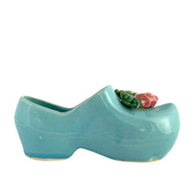 Load image into Gallery viewer, Vintage light blue figural Dutch shoe ceramic planter featuring an applied pink rose and green leaves. Crafted by McCoy Pottery, USA, 1947. Use this adorable planter to house your favourite succulent. In excellent condition, no chips/cracks/repairs. Measures 7 1/2 x 2 3/4 x 3 1/4 inches