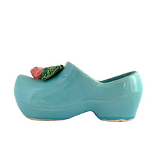 Load image into Gallery viewer, Vintage light blue figural Dutch shoe ceramic planter featuring an applied pink rose and green leaves. Crafted by McCoy Pottery, USA, 1947. Use this adorable planter to house your favourite succulent. In excellent condition, no chips/cracks/repairs. Measures 7 1/2 x 2 3/4 x 3 1/4 inches