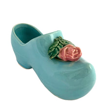 Load image into Gallery viewer, Vintage light blue figural Dutch shoe ceramic planter featuring an applied pink rose and green leaves. Crafted by McCoy Pottery, USA, 1947. Use this adorable planter to house your favourite succulent. In excellent condition, no chips/cracks/repairs. Measures 7 1/2 x 2 3/4 x 3 1/4 inches
