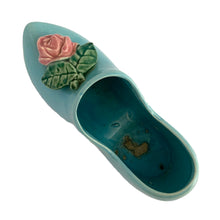 Load image into Gallery viewer, Vintage light blue figural Dutch shoe ceramic planter featuring an applied pink rose and green leaves. Crafted by McCoy Pottery, USA, 1947. Use this adorable planter to house your favourite succulent. In excellent condition, no chips/cracks/repairs. Measures 7 1/2 x 2 3/4 x 3 1/4 inches