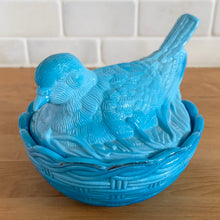 Load image into Gallery viewer, Overview side angle of Blue slag glass dove bird-on-nest styled in decor setting