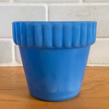 Load image into Gallery viewer, Vintage blue slag glass flower pot with ribbed pan. Produced by Akro Agate, circa 1940s. Use as intended with a small houseplant or succulent, or repurpose as a toothpick holder or upscale your office and use this as a paperclip holder. Best of all this little beauty glows beautifully under black light! In good vintage condition, free from chips/cracks. Marked 300F, Made in the USA. Measures 3 x 2 3/16 inches