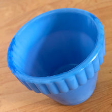 Load image into Gallery viewer, Vintage blue slag glass flower pot with ribbed pan. Produced by Akro Agate, circa 1940s. Use as intended with a small houseplant or succulent, or repurpose as a toothpick holder or upscale your office and use this as a paperclip holder. Best of all this little beauty glows beautifully under black light! In good vintage condition, free from chips/cracks. Marked 300F, Made in the USA. Measures 3 x 2 3/16 inches