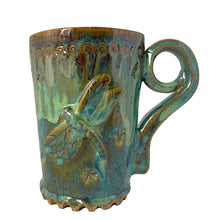 Load image into Gallery viewer, Vintage watery blue, green, ochre high fired drip glaze studio pottery mug featuring applied and debossed dragonflies with sculpted handle and scalloped base. Signed AA. This gorgeous one-of-a-kind handmade vessel is perfect for any hot beverage.
In excellent condition, no chips, cracks or repairs. Typical manufacturing glaze bubbles.
Measures 3 7/8 x 5 1/2 inches (5 7/8" incl. handle)
Capacity 16oz