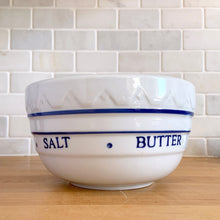 Load image into Gallery viewer, Vintage-style blue and white ceramic farmhouse mixing bowl, front three-quarter view showing embossed baking ingredients text and blue stripe and dot band around the perimeter, 2 quart