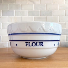 Load image into Gallery viewer, Close-up detail of the embossed baking ingredients text on the blue and white ceramic mixing bowl showing the raised lettering and blue stripe and dot pattern on white ceramic