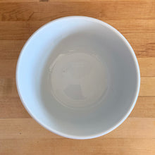 Load image into Gallery viewer, Overhead view of vintage-style blue and white ceramic farmhouse mixing bowl showing the wide open interior and decorative blue rim band