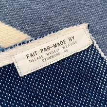 Load image into Gallery viewer, This queen-size blanket represents five decades of weaving mastery from Tissage MaGély Weaving in New Brunswick. Hand-loomed in wool and cotton by the Levesque family, its multi-blue and white striped pattern reflects the studio's commitment to traditional textile arts since 1973. Substantial enough for layering or as a primary bedcover, it delivers both visual character and genuine warmth—a functional heirloom piece for collectors of artisan-made home textiles.