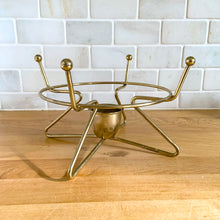 Load image into Gallery viewer, Vintage mid-century modern brass metal warming stand #468 features an atomic design with a holder for a votive candle. This stand fits a 2 quart Fire-King casserole dish., or could be used to keep a hot beverage carafe warm. In excellent used vintage condition. Measures 8 1/8 x 5 inches