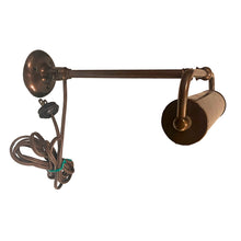Load image into Gallery viewer, Antique wall hung metal picture light with adjustable blackened brass metal shade in a deep copper-brown. This heavy-weighted lamp affixes to the wall, adjustable either upward or downward at the wall plate and the light head is extends.
In as found vintage condition, in working order. We recommend all antique/vintage lighting be upgraded to current ESA standards by a license professional.
Measures 9 1/2 x 11 inches, extends to 17 1/2 inches
