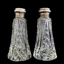 Load image into Gallery viewer, Enhance your tablescape with these sparkling vintage brilliant fine cut crystal tower-shaped salt and peppers shakers topped with sterling silver lids inlaid with mother-of-pearl....stunning!
The crystal is in excellent condition, no chips. The sterling silver lids show age related wear. Marked Sterling 925 with hallmark.
Measures 2 x 4 1/2 inches