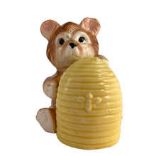 Load image into Gallery viewer, Vintage brown bear hugging a beehive ceramic salt and pepper shakers with plastic stoppers. Japan, 1970s. Add these adorable kitschy shakers to your collection!
In excellent condition, no chips/cracks/repairs. Marked Japan.
Bear measures 3 1/4 x 2 1/2 x 4 5/8 inches
Beehive measures 2 1/4 x 2 7/8 inches