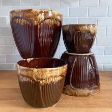 Load image into Gallery viewer, Four brown drip-glaze gothic art deco stoneware jardiniere planters in graduated sizes grouped together, showing the ribbed body and glossy tan-to-brown drip glaze on each. Robinson Ransbottom Pottery Co. USA 1930s