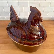 Load image into Gallery viewer, Vintage brown drip glaze hen-on-nest oven-proof casserole dish. Crafted by Hull Pottery, USA, 1960s. What a fabulous way to prepare and serve your favourite casserole!
In excellent condition, no chips/cracks/repairs. Maker's marks.
Measures 10 x 7 1/2 x 9 3/4 inches