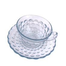 Load image into Gallery viewer, Vintage depression era "Bubble Blue" pressed glass cup and saucer set. Crafted by Anchor Hocking, USA, between 1942 - 1948. Sip a nice hot cup of tea or coffee from this classic glassware! In excellent condition, free from chips. Cup measures 3 3/4 x 2 1/4 inches Saucer measures 5 5/8 inches