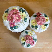 Load image into Gallery viewer, Rare set of three vintage mid-century white figural pumpkin squash ceramic canisters. These three dimensional beauties are hand painted with colourful butterflies and flowers. Each lid is topped with a floral finial. Enterprise Sales & Distributors import, Japan, 1960s. Perfect for the kitchen kitsch collectible enthusiast!
