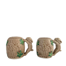 Load image into Gallery viewer, Vintage souvenir ceramic salt and pepper shakers featuring an embossed Canadian Mounted Police on horseback, green maple leaves and darling baby rabbit handles finished in tan coloured glaze. Crafted in Japan, 1950s. A sweet set of collectible shakers to use or display! In excellent condition, no chips/cracks/repairs. No corks. Measures 2 3/4 x 2 1/8 inches