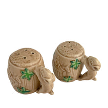 Load image into Gallery viewer, Vintage souvenir ceramic salt and pepper shakers featuring an embossed Canadian Mounted Police on horseback, green maple leaves and darling baby rabbit handles finished in tan coloured glaze. Crafted in Japan, 1950s. A sweet set of collectible shakers to use or display! In excellent condition, no chips/cracks/repairs. No corks. Measures 2 3/4 x 2 1/8 inches