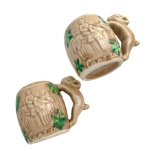 Load image into Gallery viewer, Vintage souvenir ceramic salt and pepper shakers featuring an embossed Canadian Mounted Police on horseback, green maple leaves and darling baby rabbit handles finished in tan coloured glaze. Crafted in Japan, 1950s. A sweet set of collectible shakers to use or display! In excellent condition, no chips/cracks/repairs. No corks. Measures 2 3/4 x 2 1/8 inches