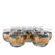 Load image into Gallery viewer, Fabulous vintage mid-century modern Carousel punch bowl with ten matching roly poly glasses and gold toned metal ladle. The glassware is decorated with carousel horses and carriages in 22kt gold on teal blue paint. Crafted by Colony, USA, circa 1960s. Perfect for serving eggnog, alcohol or non-alcohol punch at your next soirée! Stunning doesn't quite describe this fabulous set which is sure to be a standout at your next party!