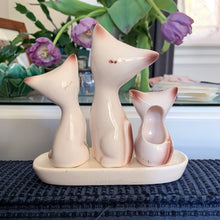 Load image into Gallery viewer, Get ready to spice up your kitchen with this oh-so-adorable cat family set of salt and pepper shakers — complete with a kitschy toothpick holder and stand! This vintage ceramic Taiwan set features a creamy white glaze with brown and black details. Purr-fect! In excellent condition, free from chips/cracks. Overall measures 5 3/4 x 2 x 6 inches
