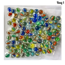 Load image into Gallery viewer, Iconic vintage Cat's Eye machine made marbles in a myriad of colours. One of the children's games of strategy and precision from the 1960s and 1970s. Purchased from the original owner. These take us back to a simpler time! These small colourful glass orbs make a wonderful display in glass jars, fish tanks and vases. In good condition and cleaned with organic soap and water. Each bag of marbles contains an assortment of colours in 9/16 inch / 14mm and 5/8 inch / 16mm