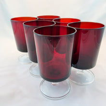Load image into Gallery viewer, Set of six, vintage Cavalier wine glasses in a luscious deep ruby red with clear footed stems. Made by Cristal D'Arques-Durand, France, 1970s.
In excellent condition, no chips. Marked France on the bottom.
Measures 2 1/2 x 4 1/2 inches
Capacity 6 ounces