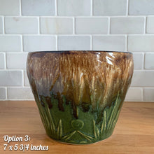 Load image into Gallery viewer, The earth and sky are represented beautifully in this large vintage mid-century Celestial Moon and Star ceramic garden planter pot featuring embossed starburst suns and moons in brown and green drip glaze. Designed and crafted by Robinson Ransbottom Pottery Company, in Roseville Ohio, USA, circa 1960s. This highly collectible planter will look gorgeous filled with your favourite greenery or flowers. Perfect for the container garden enthusiast!
Option 3: 7 1/4 x 5 5/8 inches
In excellent vintage condition