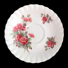 Load image into Gallery viewer, A lovely vintage Centennial Rose Monstrose shaped bone china teacup and saucer. Each piece has a lovely scalloped edge featuring a hand painted rose sprays with gold gilt trim. Crafted by Royal Albert, England, circa 1960s/70s. The perfect vessel for an excellent cuppa tea!
In excellent condition, no chips, cracks or repairs. Maker's marks on the bottom.
Teacup measures 3 1/2 x 2 3/4 inches | Saucer measures 5 1/2 inches