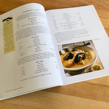 Load image into Gallery viewer, Chez Piggy is a beloved restaurant and bakery in Kingston Ontario Canada. This softcover cookbook contains 239 pages filled with wonderful recipes along with many colour photographs. Published by Firefly Books. Canada, 1988. This is the forth edition 2006. In great vintage condition with normal age-related yellowing.