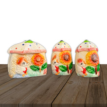Load image into Gallery viewer, Darling vintage set of salt and pepper shakers with napkin holder featuring a sweet little chick and sunflower under an umbrella on a textured wheat coloured ground. Crafted by UCAGO, Japan, circa 1950s. Dress up your kitchen collectibles with this sweet decorative and useful tableware set. In excellent used condition. Unmarked. Shakers measure 2 x 3 1/4 inches Napkin holder measures 3 1/4 x 2 1/8 x 3 1/4 inches