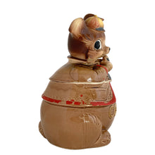 Load image into Gallery viewer, Adorable vintage, mid-century era anthropomorphic chipmunk ceramic cookie jar. Crafted by Royal Sealy, Japan, 1950s. A delightful addition to your cookie jar collection and kitchen decor!
In great vintage condition with wear to the cold paint, no chips, normal crazing commensurate with age. A crazing line extends to the unglazed portion of the lid and there is an X crazing mark on the bottom, neither goes through to the other side.
Measures 6 1/4 x 6 3/4 x 12 1/2 inches