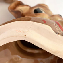 Load image into Gallery viewer, Adorable vintage, mid-century era anthropomorphic chipmunk ceramic cookie jar. Crafted by Royal Sealy, Japan, 1950s. A delightful addition to your cookie jar collection and kitchen decor!
In great vintage condition with wear to the cold paint, no chips, normal crazing commensurate with age. A crazing line extends to the unglazed portion of the lid and there is an X crazing mark on the bottom, neither goes through to the other side.
Measures 6 1/4 x 6 3/4 x 12 1/2 inches