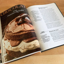 Load image into Gallery viewer, Better Homes and Gardens is known for its fabulous cookbooks. This hardcover cookbook focuses on Chocolate recipes. Its 96 pages are filled with amazing recipes along with many colour photographs. Originally published by Meredith Corporation, USA, 1984. This is the fifth printing, 1985. In great vintage condition with normal age-related yellowing.