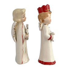 Load image into Gallery viewer, Vintage mid-century beautifully hand painted ceramic Christmas angel figurines. One, a choir boy with music song sheet and red hat and one a blonde haired girl holding a black lyre harp. Both angels wear robes of white with red trim and gold tipped wings. Made in, Japan, 1950s. These highly collectible figurines are the perfect accent for your Christmas holiday display!
Both angels are in excellent vintage condition with minor paint loss, no chips/cracks/repairs.