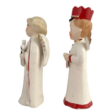 Load image into Gallery viewer, Vintage mid-century beautifully hand painted ceramic Christmas angel figurines. One, a choir boy with music song sheet and red hat and one a blonde haired girl holding a black lyre harp. Both angels wear robes of white with red trim and gold tipped wings. Made in, Japan, 1950s. These highly collectible figurines are the perfect accent for your Christmas holiday display!
Both angels are in excellent vintage condition with minor paint loss, no chips/cracks/repairs.