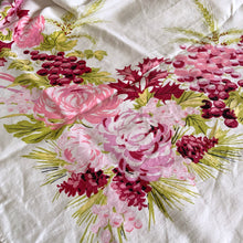 Load image into Gallery viewer, This festive vintage white cotton tablecloth is decorated with Chrysanthemums, leaves, grapes, vines, holly, berries and pinecones in shades of pink and green. A lovely table covering to add vintage charm to your celebration! In excellent condition, free from stains/tears. Measures 48 x 65 inches