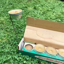 Load image into Gallery viewer, Retro insect control hits your patio with these vintage citronella candles in aluminum foil tins that sit comfortably in individual metal stands. Manufactured by F. Baillargeon Ltd., Canada, circa 1950s. This Montreal based company has been producing candles since 1896! New in box with six candles and six holders, plus instructions for use.