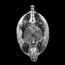 Load image into Gallery viewer, Overhead top-down view into vintage cut glass canoe bonbon dish — large starburst cut at centre, etched daisy florals around interior walls, two tab handles at each end